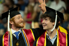 2024年本科毕业典礼上，两名学生身着毕业礼服